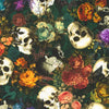 human skulls peony flowers in greens oranges purples browns on a green cotton fabric background